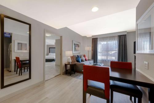 a living room with a table and a dining room at Homewood Suites Nashville Vanderbilt in Nashville