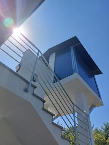 a set of stairs on a building with the sun shining at Skylab in Gozzano