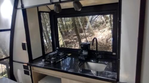 a bathroom with a sink and a window at Chalet Tanat in Medellín