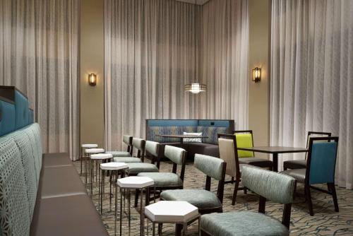 a waiting room with tables and chairs in a room at Homewood Suites By Hilton Memphis - Southaven in Southaven