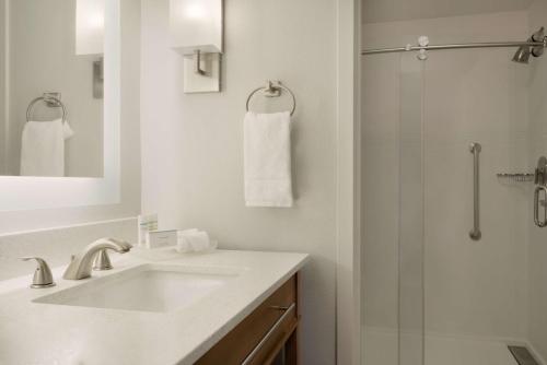 a white bathroom with a sink and a shower at Homewood Suites By Hilton Memphis - Southaven in Southaven