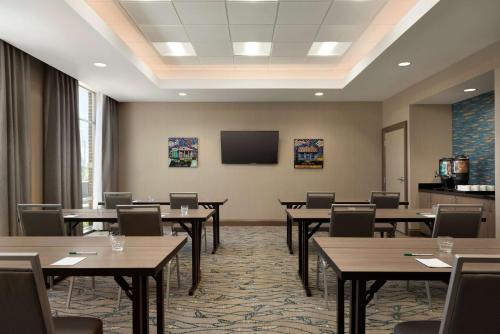 a conference room with tables and chairs and a tv at Homewood Suites By Hilton Memphis - Southaven in Southaven