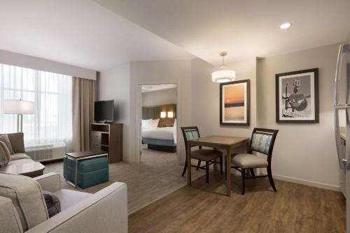 a living room with a couch and a table in a room at Homewood Suites By Hilton Memphis - Southaven in Southaven