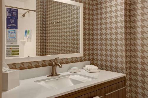 a bathroom with a sink and a mirror at Home2 Suites By Hilton San Antonio on the Riverwalk in San Antonio