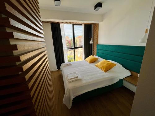 a small bedroom with a bed and a window at Мamma Mia Аpartments in Budva