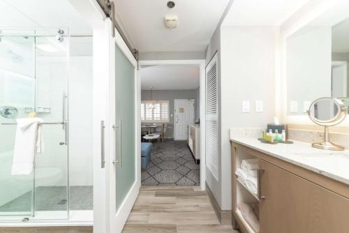 a bathroom with a shower and a sink at DoubleTree Suites by Hilton Melbourne Beach Oceanfront in Melbourne