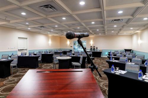 a camera in a room with tables and chairs at DoubleTree Suites by Hilton Melbourne Beach Oceanfront in Melbourne