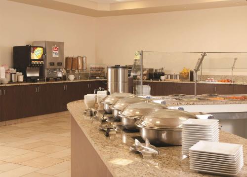 a row of pots and pans on a counter in a kitchen at Embassy Suites by Hilton Nashville Airport in Nashville