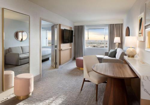 a living room with a couch and a table in a hotel room at Hilton Santa Monica in Los Angeles