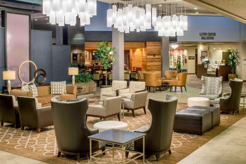 a lobby with a waiting area with chairs and tables at DoubleTree by Hilton Portland in Portland