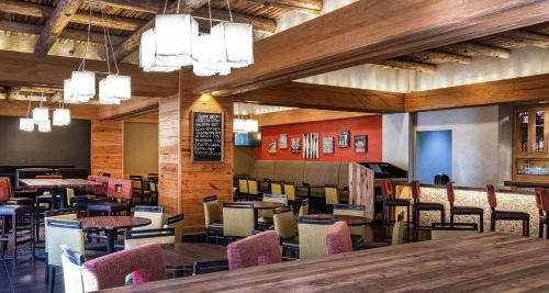 a restaurant with tables and chairs in a room at DoubleTree by Hilton Portland in Portland