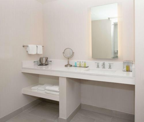 a white bathroom with a sink and a mirror at DoubleTree by Hilton Portland in Portland