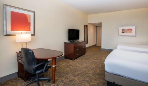 a hotel room with a bed and a desk and a bed at DoubleTree by Hilton Portland in Portland