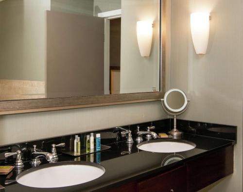 a bathroom with two sinks and a large mirror at DoubleTree by Hilton Portland in Portland