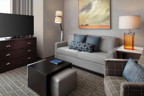 a living room with a couch and a tv at Homewood Suites By Hilton Teaneck Glenpointe in Teaneck