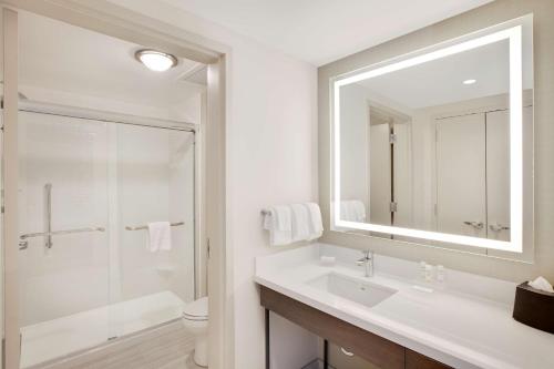 a bathroom with a sink and a shower and a mirror at Homewood Suites By Hilton Louisville Downtown in Louisville