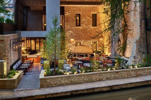 a building with a gazebo and tables and chairs at Canopy By Hilton San Antonio Riverwalk in San Antonio