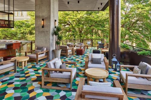 a lobby with chairs and tables on a colorful floor at Canopy By Hilton San Antonio Riverwalk in San Antonio