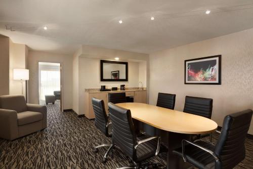 a room with a table and chairs and a desk at Embassy Suites by Hilton Convention Center Las Vegas in Las Vegas