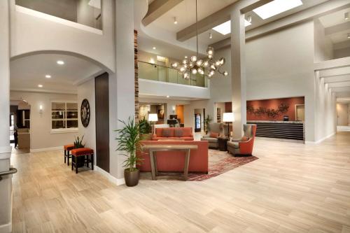 a lobby of a hospital with a table and chairs at Embassy Suites by Hilton Temecula Valley Wine Country in Temecula