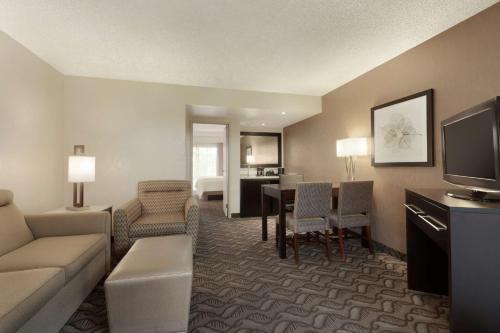 a living room with a couch and a dining room at Embassy Suites by Hilton Arcadia-Pasadena Area in Arcadia