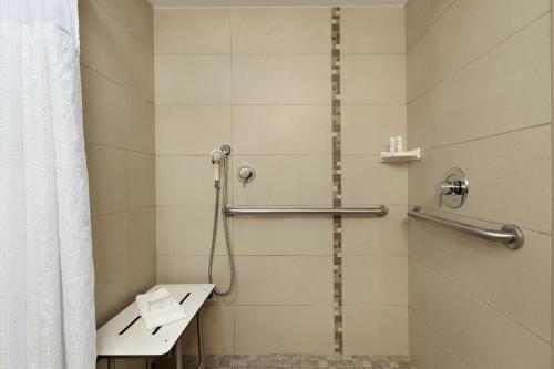 a bathroom with a shower with a toilet and a sink at Embassy Suites by Hilton Arcadia-Pasadena Area in Arcadia