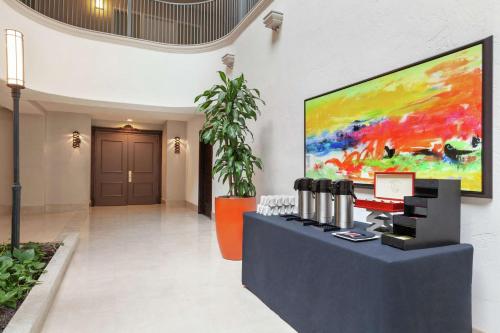a lobby with a large painting on the wall at Embassy Suites by Hilton Santa Ana Orange County Airport in Santa Ana