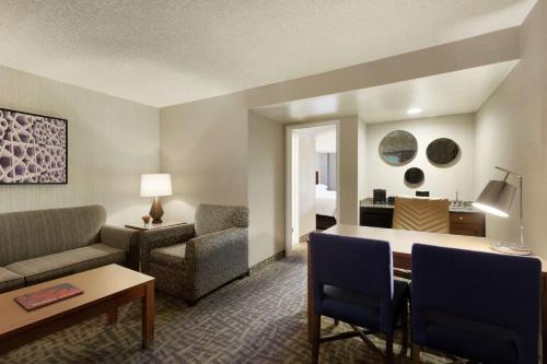 a living room with a couch and a table at Embassy Suites by Hilton Santa Ana Orange County Airport in Santa Ana