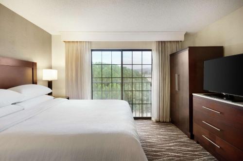 a hotel room with a bed and a large window at Embassy Suites by Hilton Lompoc Central Coast in Lompoc