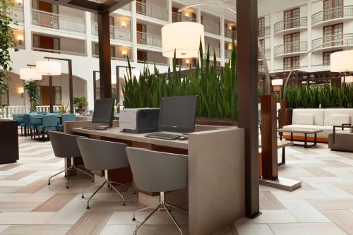 a lobby with a desk with two computers on it at Embassy Suites San Luis Obispo in San Luis Obispo