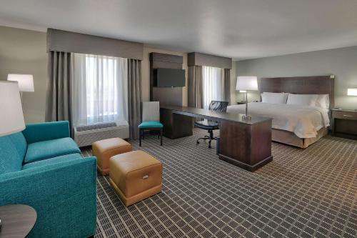 a hotel room with a bed and a desk at Hampton Inn & Suites Albuquerque Airport in Albuquerque