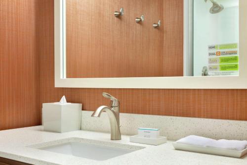 a bathroom counter with a sink and a mirror at Home2 Suites by Hilton Grovetown Augusta Area in Augusta
