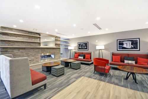 a lobby with couches and tables and a fireplace at Homewood Suites by Hilton Athens Downtown University Area in Athens