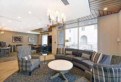 a living room with a couch and chairs and a table at Homewood Suites by Hilton Athens Downtown University Area in Athens