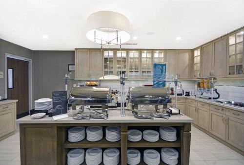 a kitchen with a counter with plates on it at Homewood Suites by Hilton Athens Downtown University Area in Athens