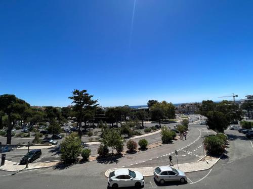 a street with cars parked in a parking lot at Estoril Casino 3 Bedrooms With Pool in Estoril