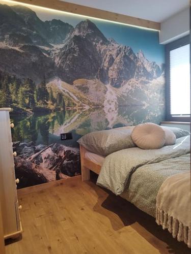 een slaapkamer met een bergmuurschildering aan de muur bij Apartament u Bobaków 2 in Bańska Niżna