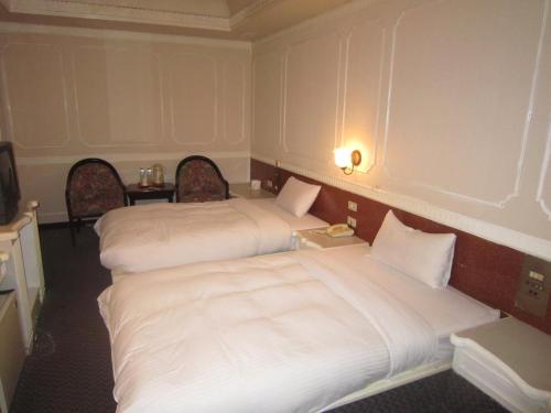 Un ou plusieurs lits dans un hébergement de l'établissement Fortune Hotel