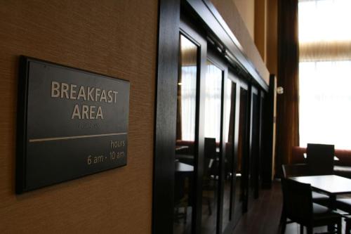 a sign on the wall of a restaurant with a table at Hampton Inn & Suites Oxford-Anniston in Oxford