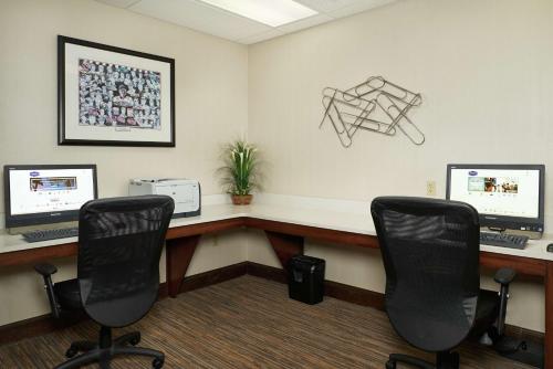 an office with two computer monitors and two chairs at Hampton Inn & Suites Oxford-Anniston in Oxford