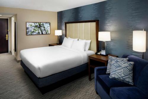 a hotel room with a bed and a couch at DoubleTree by Hilton Nashua in Nashua
