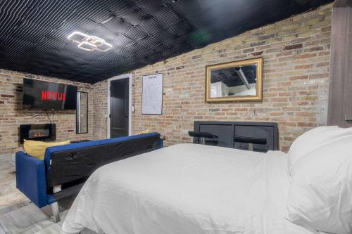 a bedroom with a bed and a brick wall at London Downtown Home in London