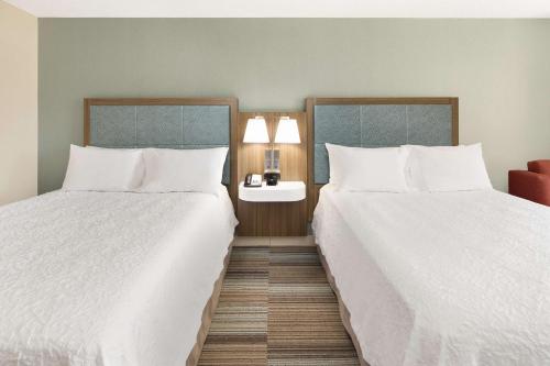 two beds in a hotel room with white sheets at Hampton Inn Atlanta-Georgia Tech-Downtown in Atlanta
