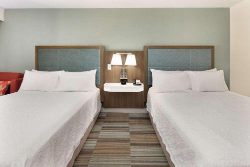 a hotel room with two beds and a table with a lamp at Hampton Inn Atlanta-Georgia Tech-Downtown in Atlanta