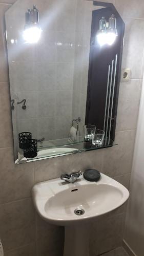 a bathroom with a white sink and a mirror at SPA - Casa do Avo BESELGA in Santo Amaro