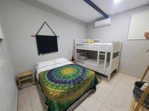 a small bedroom with a bed and a crib at LOOKING2GOOD in El Zonte