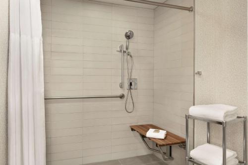 a bathroom with a shower with a shower curtain at DoubleTree by Hilton Atlanta Northeast/Northlake in Atlanta