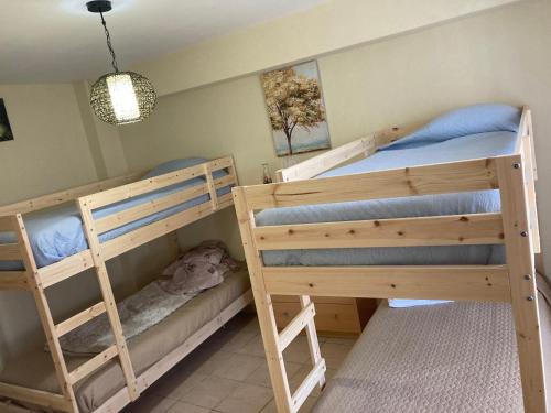 a bedroom with two bunk beds and a lamp at SPA - Casa do Avo BESELGA in Santo Amaro