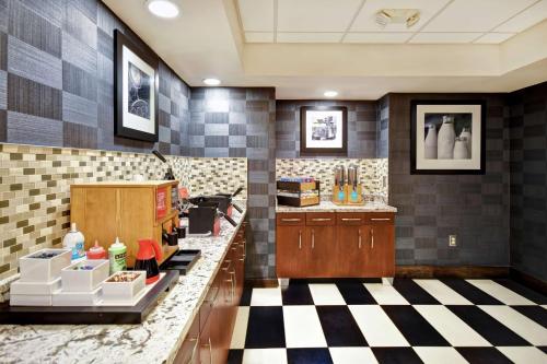 a large kitchen with a checkered floor at Hampton Inn Auburn in Auburn