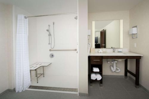 a bathroom with a shower and a sink at Homewood Suites by Hilton Austin Downtown in Austin